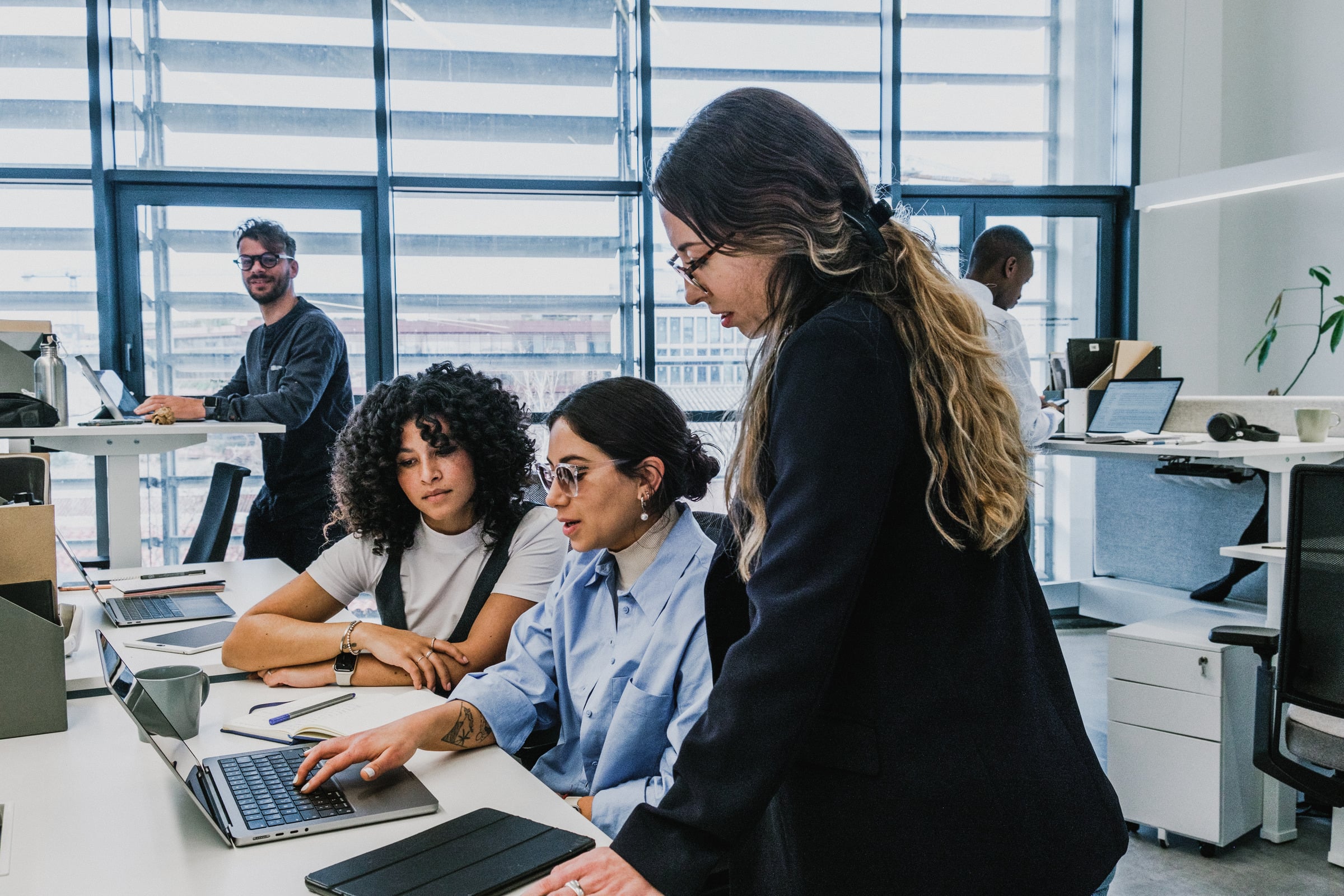A group discussing around a laptop